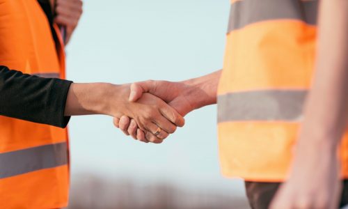 Architects handhaking after successful meeting on construction site